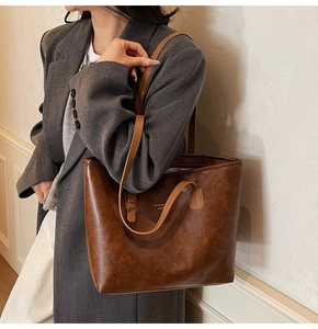Detail of dark brown tote bag with vintage texture and Fashion Leather text on side
