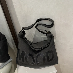 Large black canvas hobo bag with MOOD lettering and adjustable strap for women