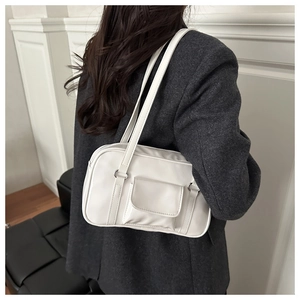 Rear view of a model wearing a white PU bowling bag with double straps and front pocket