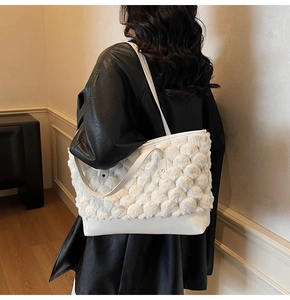 Detail of white fluffy bubble texture shoulder bag and smooth leather bottom with strap
