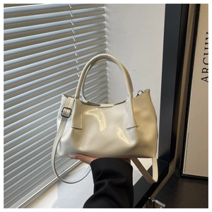 Macro shot of glossy cream white PU leather texture with metal buckle on tote bag