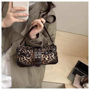 Detail of leopard print shoulder bag with vintage metal buckle and silver rivets