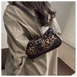Detail of leopard print underarm bag with vintage buckle and stylish rivet accents