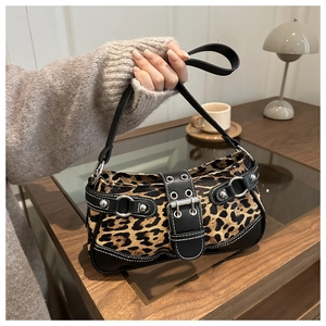 Detail of retro leopard print shoulder bag with black buckle and silver hardware accents