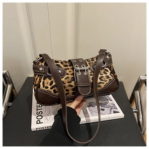 Detailed close-up of leopard print shoulder bag with leather straps and silver rivets