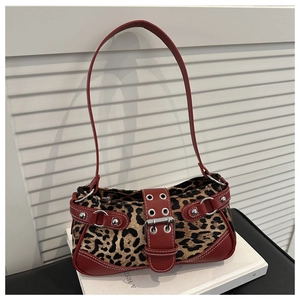 Detail view of leopard print shoulder bag with red leather trim and silver rivets
