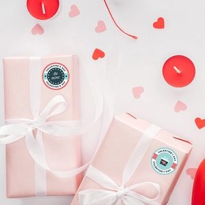 Valentine's Day round gift stickers with Be Mine text and gift box design on white background