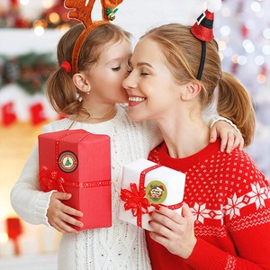 Merry Christmas round seal stickers with festive tree and snowflake motifs on gift box