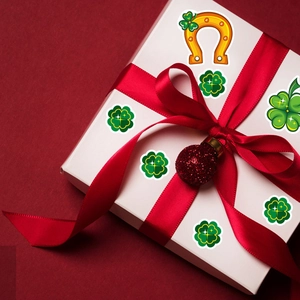 St. Patrick's Day clover stickers on gift box with green shamrocks and gold horseshoe