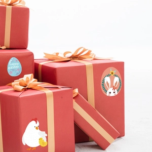 Easter decorative stickers featuring rabbits and colorful eggs on festive red gift boxes