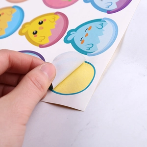 Detail of colorful Easter chick and egg stickers with easy-peel adhesive backing