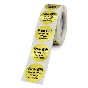 Roll of round gold self-adhesive Free Gift stickers with black text for packaging labels