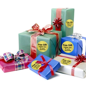 Gold Free Gift stickers with black text on colorful gift boxes for package sealing