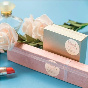 Pink and gold textured gift boxes with rose gold foil Thank You seal stickers and decor