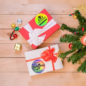 Holographic Merry Christmas and Happy New Year stickers on festive gift boxes