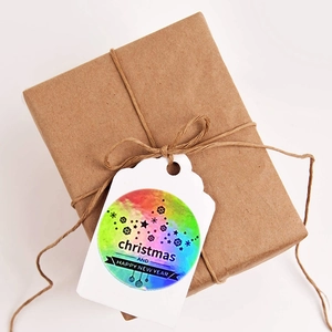 Holographic Merry Christmas and Happy New Year stickers on kraft gift box with jute rope