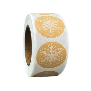 Golden Christmas snowflake stickers roll for gift wrapping and festive seal decor