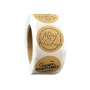 Macro shot of circular kraft Merry Christmas stickers roll for holiday gift packaging