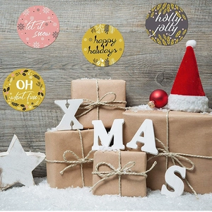 Christmas round gift stickers with festive let it snow and happy holidays designs