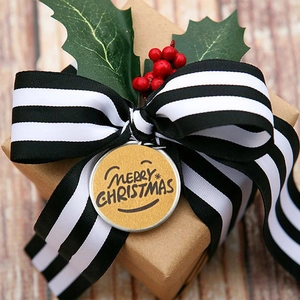 Macro detail of round Merry Christmas sticker with smiley face on gift packaging
