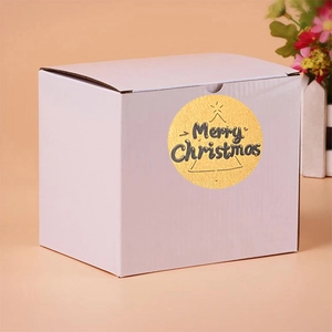 Golden Merry Christmas sticker with tree icon on white gift box packaging detail