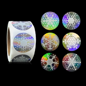 Roll of holographic silver snowflake stickers with Merry Christmas design on black background