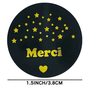 Black round Merci stickers with gold foil stars and 3.8cm diameter label roll