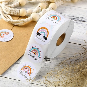 Rainbow Thank You stickers roll for gift packaging on vintage wood background