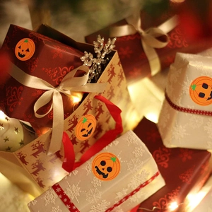 Orange Halloween pumpkin face stickers on gift boxes for festive party decoration