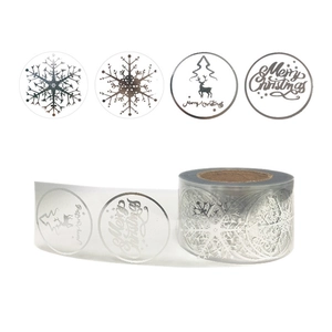 Silver foil Christmas stickers featuring snowflakes and reindeer on transparent rolls