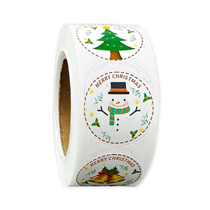 Close-up of a roll of black Merry Christmas stickers with gold foil festive patterns
