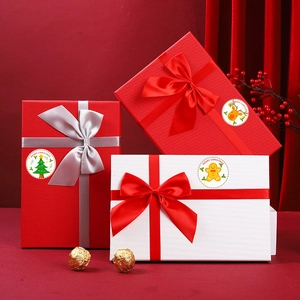 Close-up of laser silver Merry Christmas stickers with snowflakes on festive gift boxes