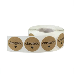 Brown kraft paper stickers with black Obrigado text and heart for gift packaging