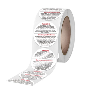 Rouleau d'étiquettes de sécurité rondes pour bougies avec texte noir et rouge sur blanc