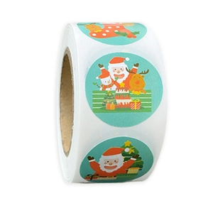 Detail of laser-cut Merry Christmas stickers on roll with reindeer and Santa patterns