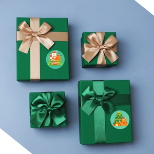 Detail of Christmas gift boxes with silver snowflakes and festive holiday stickers