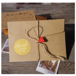 Vintage kraft paper envelope set with twine, red heart wooden clip, and thank you sticker