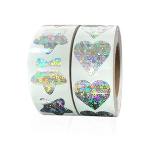 Macro detail of laser silver snowflake Christmas stickers with holographic star and heart patterns