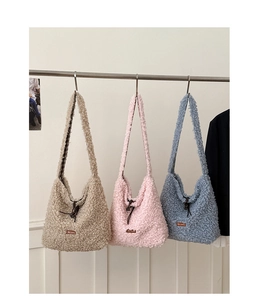 Detailed view of plush teddy fabric shoulder bags with drawstring in beige, pink and blue