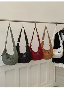 Detailed display of five canvas tote bags in green, black, burgundy, caramel, and cream