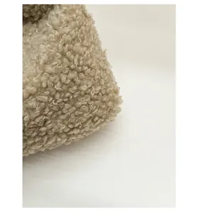 Macro shot of soft sherpa fleece fabric detail on beige large capacity tote bag