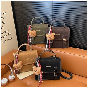 Detail showing four vintage leather backpacks in olive, brown, khaki, and black colors