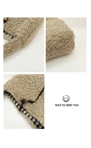 Detailed view of beige faux shearling tote with plaid lining and drawstring closure