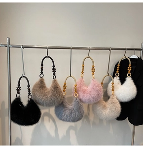 Detailed display of plush faux fur hobo bags in various colors with wooden bead handles