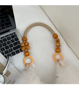 Detail of plush faux fur shoulder strap with wooden beads and woven cream cord accents