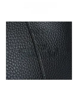 Detailed close-up of premium black lychee-grain leather texture with neat stitching detail