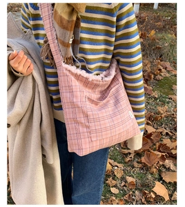 Pink checkered plush tote bag with cozy fleece lining and convenient front pocket