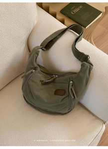 Détails du sac hobo en toile vert olive avec large bandoulière et poches zippées