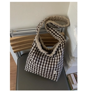 Detail of checkered tote bag featuring plush faux fur trim on the strap and top edge