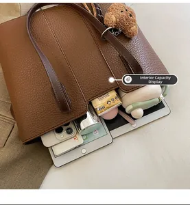 Internal capacity display of large brown lychee texture tote bag with daily essentials